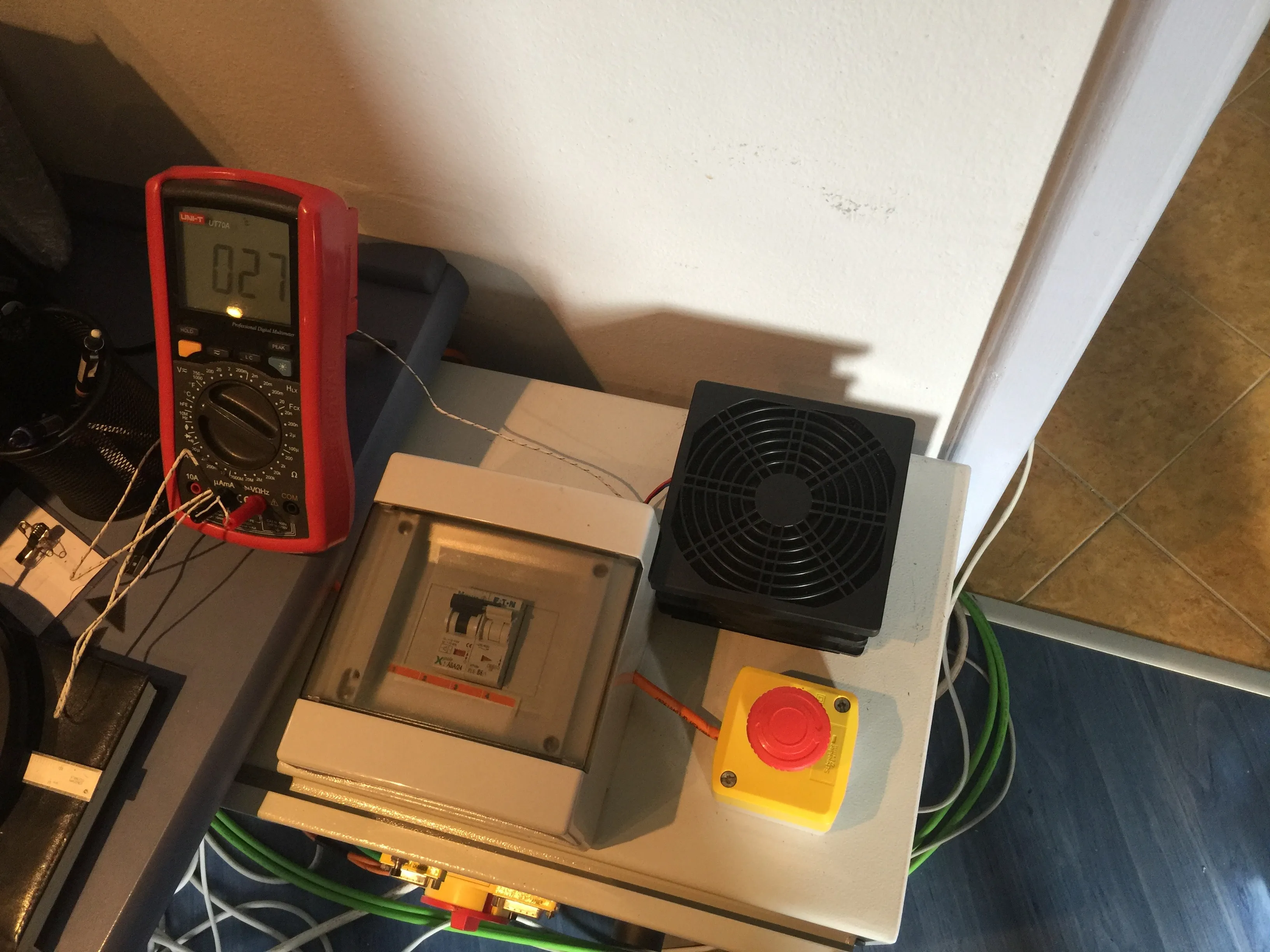 Measuring air temperature inside electric enclosure after installing fans